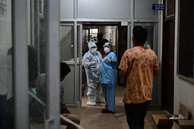 May 3, 2021, Prayagraj, Uttar Pradesh, India: Prayagraj: Doctors and medical workers wear PPE kit talk with family members of COVID19 patient outside Corona ward at Swaroop Rani Neharu Hospital in Allahabad on Monday, May 03, 2021. Prayagraj India - ZUMAv115 20210503_zap_v115_024 Copyright: xPrabhatxKumarxVermax