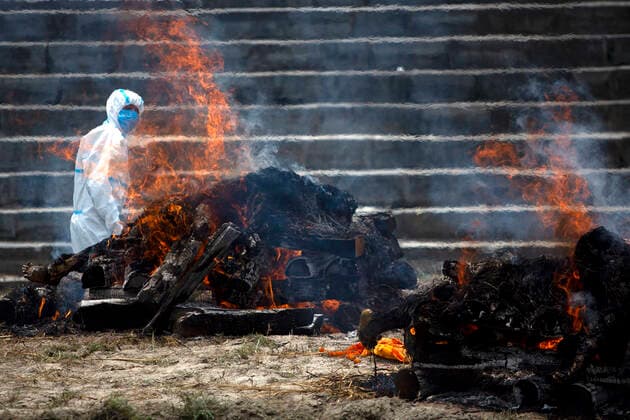 (210503) -- KATHMANDU, May 3, 2021 -- A worker cremates victims who died from COVID-19 at Pashupatinath Temple crematorium in Kathmandu, Nepal, May 3, 2021. (Photo by Xinhua) NEPAL-KATHMANDU-COVID-19 VICTIMS-CREMATION SulavxShrestha 