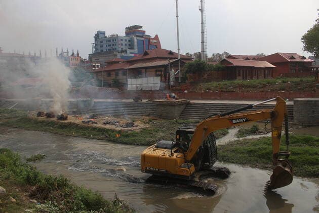 Workers from the crematorium light funeral pyres over the bodies of Covid-19 victim Workers from the crematorium light funeral pyres over the bodies of COVID-19 victims along the banks of the Bagmati river, owing to the second wave of the coronavirus pandemic on the fifth-day of a government imposed lockdown. Nepal Copyright: DipendraxDhungana