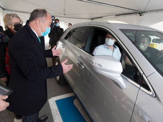 May 4, 2021, Montreal, PQ, Canada: Quebec Health Minister Christian Dube, left, chats with Alex Smirnov, centre, and Timur Tchanychev, right, at a demonstration of a drive-through vaccination site, Tuesday, May 4, 2021 in Montreal. The site will be able to give 4,000 doses a day. Montreal Canada - ZUMAc35_ 20210504_zaf_c35_004 Copyright: xRyanxRemiorzx