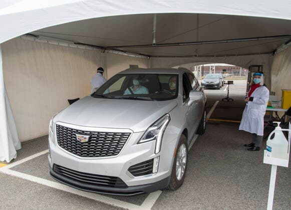 May 4, 2021, Montreal, PQ, Canada: Alex Smirnov, driver, and Timur Tchanychev, passenger, pull out of the tent after receiving their COVID-19 shots at a demonstration of a drive-through vaccination site, Tuesday, May 4, 2021 in Montreal. The site will be able to give 4,000 doses a day. Montreal Canada - ZUMAc35_ 20210504_zaf_c35_005 Copyright: xRyanxRemiorzx