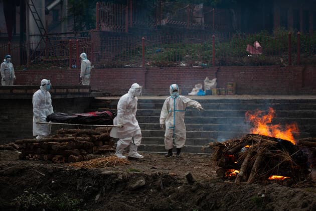 Coronavirus Emergency In Nepal Workers donned in Personal Protective Equipment (PPE) carry a body of a deceased who succumbed to COVID-19 for cremation on the bank of Bagmati River in Kathmandu, Nepal on Tuesday, May 4, 2021. As the second wave of Corona Virus infection sweeps Nepal only crematorium in Kathmandu Valley is struggling to cope with the flow of dead bodies. As an alternative to the crematorium, cremations are being conducted in an open ground. Kathmandu Nepal shrestha-notitle210504_npXeT  Copyright: xRojanxShresthax