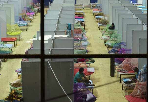 COVID-19 patients at a sports complex, converted into a Covid care center, receive care in New Delhi, India, Tuesday, May 4, 2021. More than 20 million Indians have been infected with the coronavirus as it continues to spread with 3,500 deaths in the past 24 hours.  DEL2021050412 Abhishek