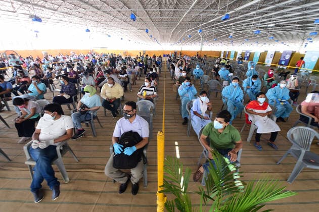People wait to receive COVID-19 vaccine doses at one of the largest vaccination sites at Radhaswami Satsang, in New Delhi, India, Tuesday, May 4, 2021. More than 20 million Indians have been infected with the coronavirus as it continues to spread with 3,500 deaths in the past 24 hours.  DEL2021050431 Abhishek