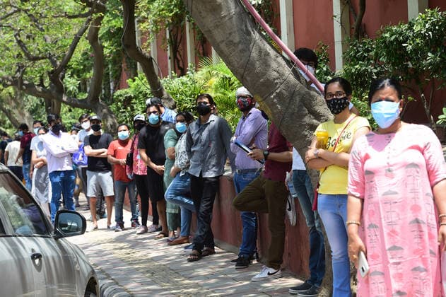 People wait for hours to receive COVID-19 vaccine doses at one of the largest vaccination sites at Radhaswami Satsang, in New Delhi, India, Tuesday, May 4, 2021. More than 20 million Indians have been infected with the coronavirus as it continues to spread with 3,500 deaths in the past 24 hours.  DEL2021050437 Abhishek