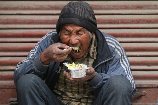 May 5, 2021, Kathmandu, NE, Nepal: People eat their morning meal provided by the 100 s Group, a youth charity, during the lockdown in Kathmandu, Nepal, May 5, 2021. Kathmandu Nepal - ZUMAd164 20210505_zip_d164_003 Copyright: xAryanxDhimalx