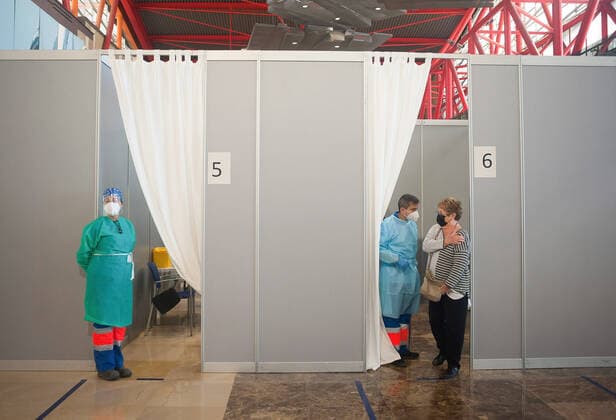 May 5, 2021, Malaga, Spain: A woman wearing a face mask as a precaution against the spread of covid-19 seen speaking with a nurse after she was vaccinated during a massive vaccination at Fair and Congresses Palace..Health regional authorities have retimed again the vaccination with doses of Pfizer BioNTech inside large and secure places following all protective measures, as part of massive vaccination One million plan after the announcement of Andalusian government to inoculate around 600.000 vaccines during the week. Malaga Spain - ZUMAs197 20210505_zaa_s197_023 Copyright: xJesusxMeridax