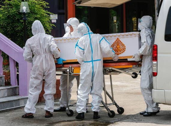 May 5, 2021, Nonthaburi, Thailand: (EDITORS NOTE: Image depicts death).Rescue workers wearing personal protective equipment suites (PPE) carry a coffin of a COVID-19 victim for crematorium during a free cremation funeral service for a COVID-19 victim with monks in attendance of the ceremony at Wat Bang Muang, in Nonthaburi province. .The government on Wednesday reported 15 new Covid-19 deaths, bringing the toll to 318, and 2,112 new cases, raising the total to 74,900. Nonthaburi Thailand - ZUMAs197 20210505_zaa_s197_078 Copyright: xChaiwatxSubprasomx