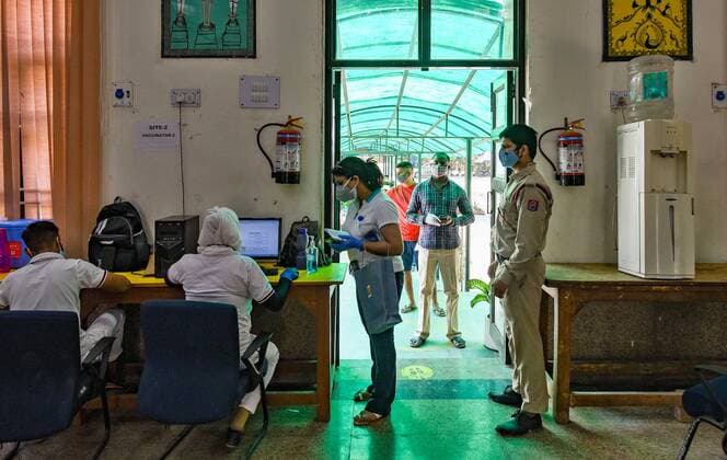 NEW DELHI, INDIA - MAY 5: People queue during the third phase of vaccination at Girls senior secondary school, Chhatarpur on May 5, 2021 in New Delhi, India. (Photo by Amal KS Hindustan Times) COVID-19 Vaccination Drive