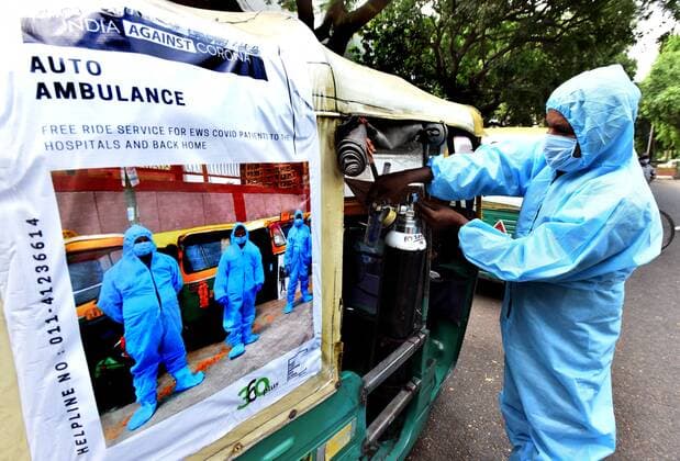 NEW DELHI, INDIA - MAY 5: Auto-Rickshaw Driver in personal cover protective equipment (PPE) Into Ambulance, with Oxygen Facility offers Free Rides to COVID Patients, Delhi Rajya Sabha MP Sanjay Singh start auto Ambulance for EWS persons in the capital, on May 5, 2021 in New Delhi, India. (Photo by Sonu Mehta Hindustan Times) Auto-Ambulances With Oxygen Support Launched In Delhi