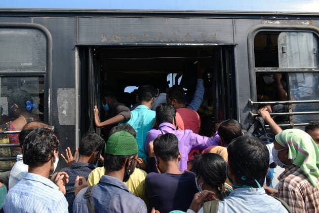 Transportation problem due to Covid-19 Pandemic in Kolkata People are trying to pickup a government Bus after suspended of local train service and government-run transport services curtailed by 50 per cent, amidst the spread of the coronavirus disease (COVID-19), in Kolkata. Kolkata West Bengal India Copyright: SudiptaxDas