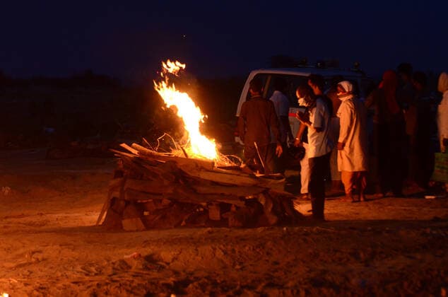 May 6, 2021, Prayagraj, Uttar Pradesh, India: Prayagraj: Relatives perform last rites of a relative who was thought to have died of Covid-19 to a funeral pyre at a mass crematorium site on the banks of the Ganga river on May 06, 2021 in Allahabad, India. India recorded more than 360,000 coronavirus cases in a day for the 12th day in a row on Monday as the total number of those infected according to Health Ministry data neared 20 million. The real figure could be up to ten times higher, many health experts say, due to a lack of widespread testing or reporting, and only patients who succumbed in hospitals being counted. A new wave of the pandemic has totally overwhelmed the country s healthcare services and has caused crematoriums to operate - ZUMAv115 20210506_zap_v115_038 Copyright: xPrabhatxKumarxVermax