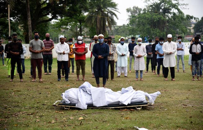 May 6, 2021, Guwahati, Assam, India: Family members offer Namaz (Islamic funeral prayer) before performing the last rites of a person who died due to COVID-19 disease at Athgaon Kabarsthan in Guwahati Assam India. Guwahati India - ZUMAd163 20210506_zip_d163_003 Copyright: xDasarathxDekax