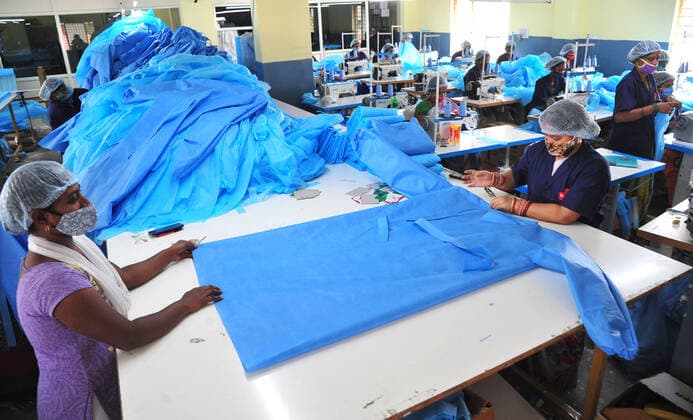 (210506) -- BANGALORE, May 6, 2021 () -- Workers process personal protective equipment (PPE) kits for hospitals at a factory in Bangalore, India, on May 6, 2021. Due to growing demands for PPE kits, employees of this factory are working around the clock in double shifts. (Str ) INDIA-BANGALORE-PPE KITS MANUFACTURING Xinhua 