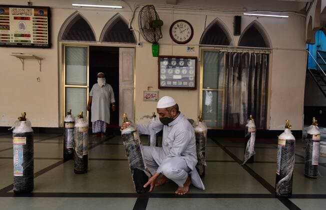 MUMBAI, INDIA - MAY 6: A volunteer from the Muslim community checks oxygen cylinders before being distributed free to the needy at Khokha Masjid, Nagdevi Street on May 6, 2021 in Mumbai, India. (Photo by Anshuman Poyrekar Hindustan Times) India Faces Oxygen Crisis As Covid-19 Cases Mount