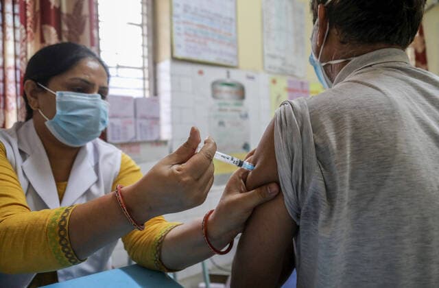 May 6, 2021, New Delhi, India: A health worker inoculates a man with a dose of the Covaxin coronavirus COVID-19 vaccine by Bharat Biotech at a vaccination centre..Indian Supreme Court (Apex court) says that the country needs to be prepared for the third surge of Covid19 which could be more harmful for children. India has reported 412,431 new Covid-19 virus cases and 3,980 deaths in past 24 hours, the highest in a day so far. New Delhi India - ZUMAs197 20210506_zaa_s197_198 Copyright: xNaveenxSharmax