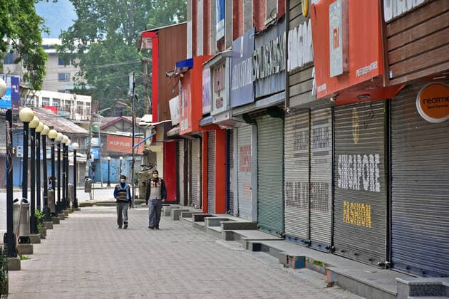 May 7, 2021, Srinagar, India: Pedestrians walk past closed shops during a lockdown imposed by the authorities following the surge in coronavirus cases in Srinagar..Normal life remained affected in Jammu and Kashmir on the ninth day of the last Friday of Ramadan with the imposition of lockdown following an alarming surge in coronavirus cases. India reported a record daily rise in coronavirus cases of 414,188, while deaths from COVID-19 swelled by 3,915 in the last 24 hours. Srinagar India - ZUMAs197 20210507_zaa_s197_010 Copyright: xSaqibxMajeedx