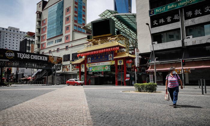 May 7, 2021, Kuala Lumpur, Malaysia: A woman wearing a face mask walks on a deserted road near the China Town in Kuala Lumpur..The federal territory of Kuala Lumpur, the capital city of Malaysia is placed under the movement control order (MCO) from May 7 to May 20, 2021 due to the rise in daily cases of Covid-19 infection. Kuala Lumpur Malaysia - ZUMAs197 20210507_zaa_s197_023 Copyright: xWongxFokxLoyx
