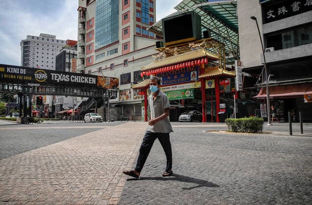 May 7, 2021, Kuala Lumpur, Malaysia: A man wearing a face mask walks on a deserted road near the China Town in Kuala Lumpur..The federal territory of Kuala Lumpur, the capital city of Malaysia is placed under the movement control order (MCO) from May 7 to May 20, 2021 due to the rise in daily cases of Covid-19 infection. Kuala Lumpur Malaysia - ZUMAs197 20210507_zaa_s197_024 Copyright: xWongxFokxLoyx