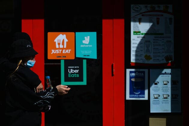 Daily Life In Dublin During COVID-19 Lockdown A woman wearing a face mask walks past a takeout restaurant with food delivery company stickers on a door in Dublin city center during the final days of the COVID-19 lockdown. On Friday, 7 May 2021, in Dublin, Ireland. Dublin Ireland widak-dublinda210507_npsCV  Copyright: xArturxWidakx