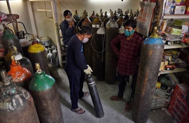 NEW DELHI, INDIA - MAY 7: Peope at an oxygen cylinder refilling centre at Bhogal on May 7, 2021 in New Delhi, India. (Photo by Ajay Aggarwal Hindustan Times) India Faces Oxygen Crisis As Covid-19 Cases Mount