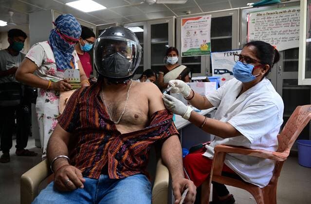 May 8, 2021, Prayagraj, Uttar Pradesh, India: Prayagraj: A medical worker inoculates a youth with a dose of Covaxin, vaccine against the Covid-19 coronavirus at Moti Lal Nehru Medical College in Allahabad on Thursday, May 08, 2021. Prayagraj India - ZUMAv115 20210508_zap_v115_007 Copyright: xPrabhatxKumarxVermax