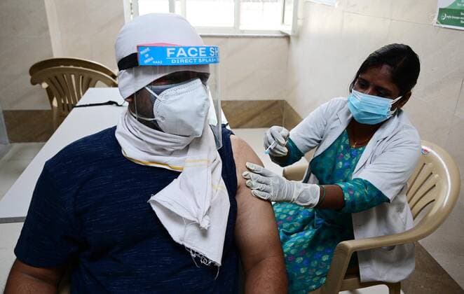 May 8, 2021, Prayagraj, Uttar Pradesh, India: Prayagraj: A medical worker inoculates a youth with a dose of Covaxin, vaccine against the Covid-19 coronavirus at Moti Lal Nehru Medical College in Allahabad on Thursday, May 08, 2021. Prayagraj India - ZUMAv115 20210508_zap_v115_008 Copyright: xPrabhatxKumarxVermax