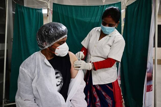 May 8, 2021, Prayagraj, Uttar Pradesh, India: Prayagraj: A medical worker inoculates a youth with a dose of Covaxin, vaccine against the Covid-19 coronavirus at Moti Lal Nehru Medical College in Allahabad on Thursday, May 08, 2021. Prayagraj India - ZUMAv115 20210508_zap_v115_015 Copyright: xPrabhatxKumarxVermax