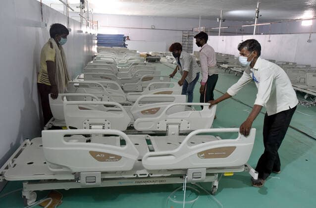 NEW DELHI, INDIA - MAY 9: Workers construct a temporary Covid care centre at Ramlila Maidan in front of LNJP hospital, keeping in the view the surging Covid cases, the Delhi government has decided to set up 500 ICU beds at historic Ramlila Maidan to treat Covid patients, on May 9, 2021 in New Delhi, India. (Photo by Sonu Mehta Hindustan Times ) Daily Life Amid Coronavirus Pandemic In India