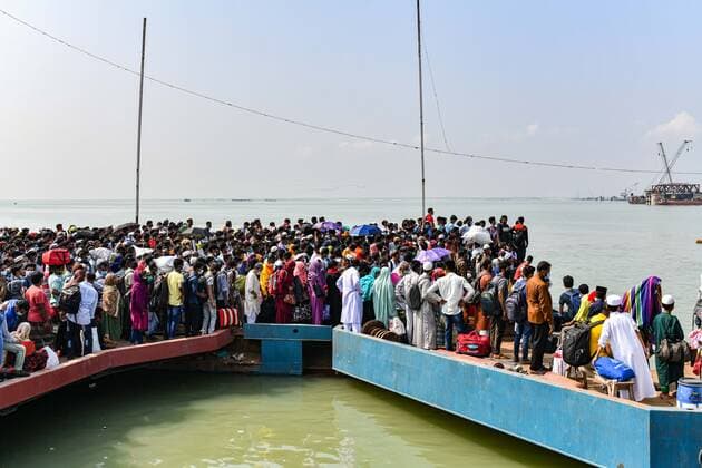 May 9, 2021, Munshiganj, Bangladesh: Migrant people wait for a ferry to get home to celebrate Eid al-Fitr amid concerns over the coronavirus disease (COVID-19) outbreak in Munshiganj on the outskirts of Dhaka...Despite the suspension on daytime ferries and the deployment of BGB (Border Guards Bangladesh) troops, the crowds of people hoping to make their way home for Eid are still swelling at Shimulia, a river port. Munshiganj Bangladesh - ZUMAs197 20210509_zaa_s197_125 Copyright: xZabedxHasnainxChowdhuryx
