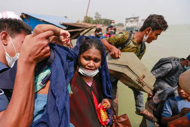 May 9, 2021, Manikganj, Bangladesh: Bangladeshi people try to get on board of an overcrowded ferry to go their village homes for the Eid al-Fitr festival in Paturiya, Manikganj, on the outskirts of Dhaka, Bangladesh, May 9, 2021. Mad rush of Eid-home-goers has now been prevailing from Bangladeshi cities and towns ahead of the Muslim Eid al-Fitr festival, despite the fact that the government asked all to stay at their present locations to limit the spread of the COVID-19. Manikganj Bangladesh - ZUMAd117 20210509_zap_d117_006 Copyright: xSuvraxKantixDasx