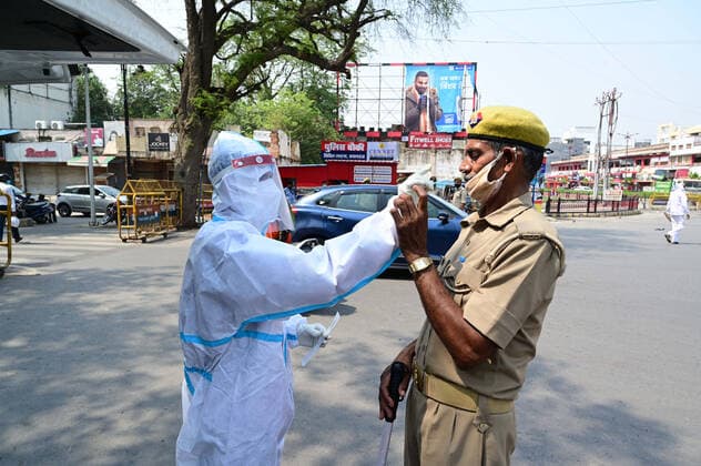 May 10, 2021, Prayagraj, Uttar Pradesh, India: Prayagraj: A Health worker taking swab sample of policeman a deserted road during government imposed lockdown to curb the spread of Coronavirus in Prayagraj on Thursday, May 10, 2021. Prayagraj India - ZUMAv115 20210510_zap_v115_026 Copyright: xPrabhatxKumarxVermax