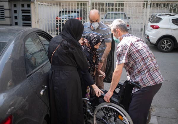 Vaccination Of People Over 80 Years By The China s Sinopharm COVID-19 Vaccine In Tehran Relatives of an Iranian elderly woman (C) help her for sitting on a wheelchair out of a health center as she arrives tp receive a dose of China s Sinopharm new coronavirus disease (COVID-19) vaccine in northern Tehran on May 10, 2021. MORTEZA NIKOUBAZL NurPhoto Tehran Tehran Iran nikoubazl-vaccinat210510_npxhI  Copyright: xMortezaxNikoubazlx