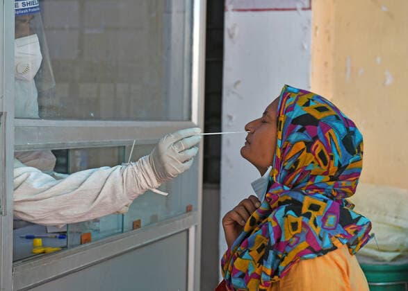 India: COVID-19 tests amid Pandemic in Rajasthan A health worker collects nasal swab sample from a woman at a COVID-19 testing lab during second wave of coronavirus epidemic, in Beawar. The health ministry on Monday reported 366,161 new infections and 3,754 deaths. India’s tally of infections now stands at 22.66 million, with 246,116 deaths. 80 doctors at Delhi s Saroj Hospital tested positive for coronavirus. Beawar Rajasthan India Copyright: SumitxSaraswat