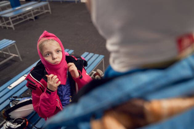 Back view father in warm sportswear putting on ski face mask and while standing near kid in sports club, Model released Copyright: xSergeyxMironovx MR
