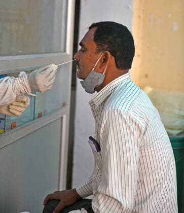 India: COVID-19 tests amid Pandemic in Rajasthan A health worker collects nasal swab sample from a man at a COVID-19 testing lab during second wave of coronavirus epidemic, in Beawar. The health ministry on Monday reported 366,161 new infections and 3,754 deaths. India’s tally of infections now stands at 22.66 million, with 246,116 deaths. 80 doctors at Delhi s Saroj Hospital tested positive for coronavirus. Beawar Rajasthan India Copyright: SumitxSaraswat