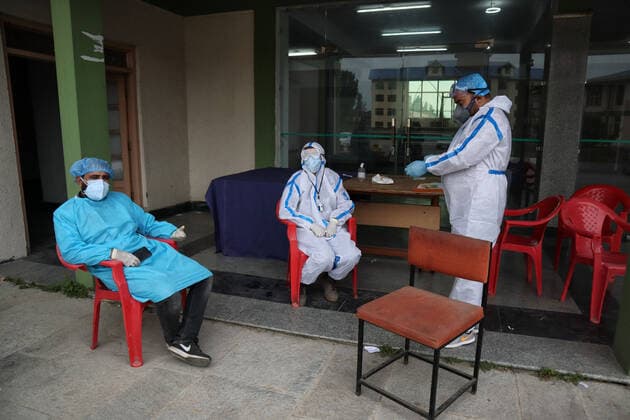 May 8, 2021: Health workers rest outside temporary Covid-19 hospital in Srinagar, Indian Administered Kashmir on 08 May 2021. A Local NGO Athrout has converted Hajj house into a 100-bedded Covid centre as the space in hospitals is filling up fast - ZUMAd99_ 20210508_zap_d99_053 Copyright: xMuzamilxMattoox