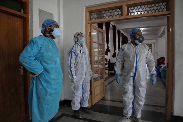 May 8, 2021: Health workers stand outside temporary Covid-19 hospital in Srinagar, Indian Administered Kashmir on 08 May 2021. A Local NGO Athrout has converted Hajj house into a 100-bedded Covid centre as the space in hospitals is filling up fast - ZUMAd99_ 20210508_zap_d99_065 Copyright: xMuzamilxMattoox