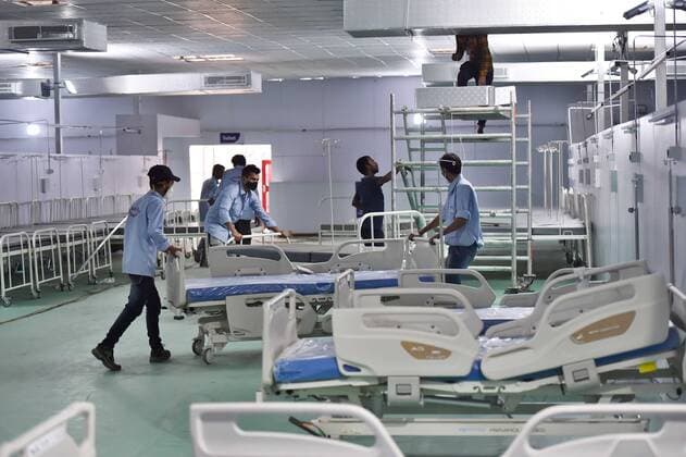 NEW DELHI, INDIA - MAY 11: Workers setting up a 500-bed Covid-19 Care Centre at Ramlila Maidan in front of LNJP hospital on May 11, 2021 in New Delhi, India. (Photo by Ajay Aggarwal Hindustan Times) 500-ICU Bed Covid Care Centre At Ramlila Maidan Near LNJP Hospital