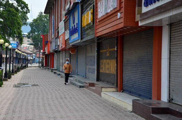 May 12, 2021, Srinagar, Jammu & Kashmir, India: A man wearing a face mask walks through a closed market during a strict curfew imposed following the surge in COVID-19 cases in Srinagar. .A day after several areas in Kashmir valley witnessed a huge rush of people ahead of Eid festival, strict curfew has been imposed in the valley as authorities enforced the lockdown to contain an alarming surge in coronavirus cases. Meanwhile, India recorded 348,421 new COVID-19 cases and 4,200 deaths in the last 24 hours. Srinagar India - ZUMAs197 20210512_zaa_s197_042 Copyright: xSaqibxMajeedx