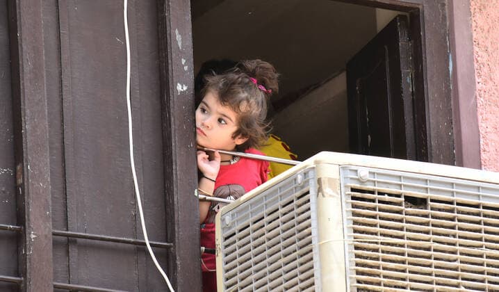India: Daily Life amid COVID-19 lockdown in Rajasthan A girl child look out from window of her house during lockdown imposed by state government to curb the surge in COVID-19 cases, in Beawar. Beawar Rajasthan India Copyright: SumitxSaraswat