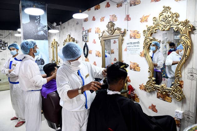 May 12, 2021, Dhaka, Bangladesh: Barbers wearing personal protective equipment (PPE) as a preventive measure against the spread of COVID19 attend to their salon clients in Dhaka. Dhaka Bangladesh - ZUMAs197 20210512_zaa_s197_072 Copyright: xPiyasxBiswasx