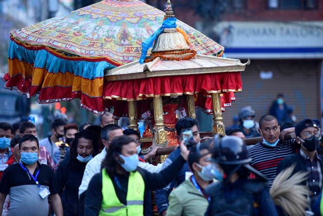 Longest Festival Rato Machindranath Begins During Prohibitory Lockdown In Kathmandu Valley Nepalese Priest carrying idol Rato Machindranath from Machindra Bahal towards the chariot on the first day of the longest chariot festival of Nepal during prohibitory lockdown of covid pandemic in Lalitpur, Nepal on Wednesday, May 12, 2021. Rato Machindranath is also said as the God of Rain and both Hindus and Buddhists worship the Machindranath in hope of good rain to prevent drought during the rice plantation season. Lalitpur NP Nepal maharjan-longestf210512_npO7M  Copyright: xNarayanxMaharjanx