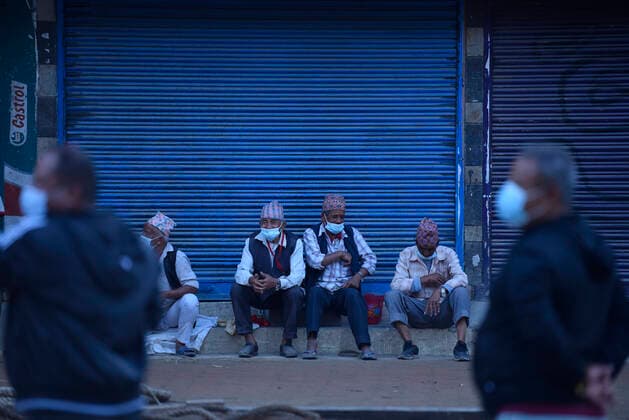 Longest Festival Rato Machindranath Begins During Prohibitory Lockdown In Kathmandu Valley Nepalese devotees take rest after making chariot of the Rato Machindranath on the first day of the longest chariot festival of Nepal during prohibitory lockdown of covid pandemic in Lalitpur, Nepal on Wednesday, May 12, 2021. Rato Machindranath is also said as the God of Rain and both Hindus and Buddhists worship the Machindranath in hope of good rain to prevent drought during the rice plantation season. Lalitpur NP Nepal maharjan-longestf210512_npuM7  Copyright: xNarayanxMaharjanx