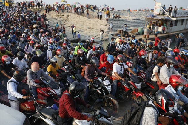 COVID-19 Coronavirus Emergency In Bangladesh People on motorcycles rush to board a ferry at Mawa Ferry Terminal to get home to celebrate Eid al-Fitr, after the government imposed coronavirus disease (COVID-19) restrictions on long-route public transport in Munshiganj, Bangladesh on May 12, 2021. Munshiganj Bangladesh salahuddin-notitle210512_npVOz  Copyright: xKazixSalahuddinxRazux