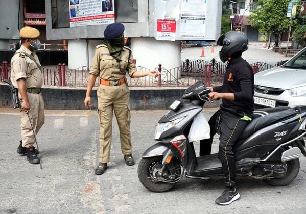 Coronavirus Emergency In India Security personnel question commuters who defied curfew as coronavirus cases surge in Guwahati, India Thursday, May 13, 2021. Guwahati India hazarika-notitle210513_npiix  Copyright: xAnuwarxHazarikax
