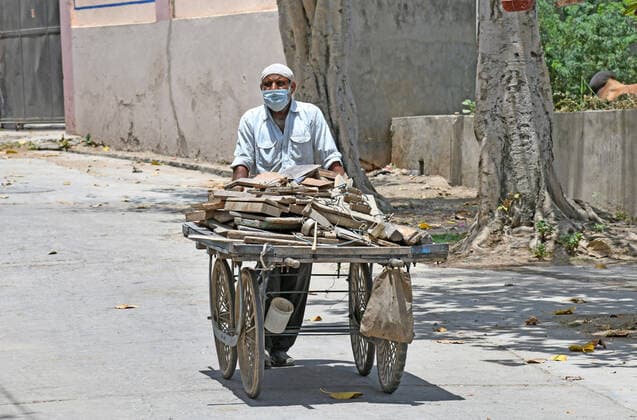 Cremation Of COVID-19 Victims In Rajasthan, India A worker pulls a handcart loaded with firewood for cremation of COVID-19 victim at Hindu Moksha Dham Crematorium in Beawar. Beawar Rajasthan India Copyright: SumitxSaraswat