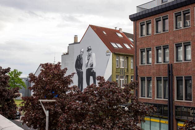 Architektur von Hans Hollein Joseph Beuys in Mönchengladbach Graffiti depicting an architect Hans Hollein and famous artist Joseph Beuys on Johann-Peter-Boelling-Platz in Mönchengladbach, North Rhine Westphalia on May 13, 2021. The graffiti was supported by the Museum Abteiberg and was created by the graffiti artist Philipp Kömen.