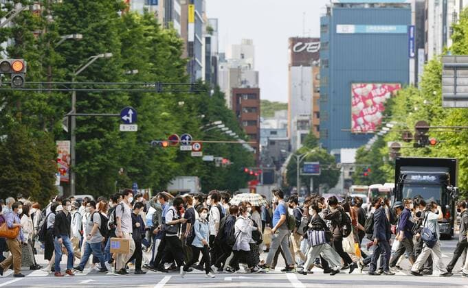 Tokyo under virus emergency People wearing face masks walk at a crossing in Tokyo s Akihabara area on May 15, 2021, as the capital remains under a coronavirus state of emergency. 