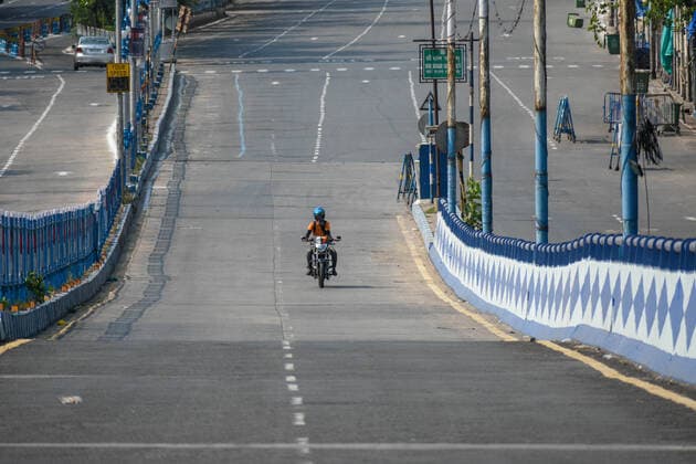 May 16, 2021, Kolkata, West Bengal, India: A delivery boy rides through an almost empty road during first day of 14 day lockdown in Kolkata , India , on 16 May 2021 Kolkata India - ZUMAc211 20210516_zip_c211_004 Copyright: xDebarchanxChatterjeex